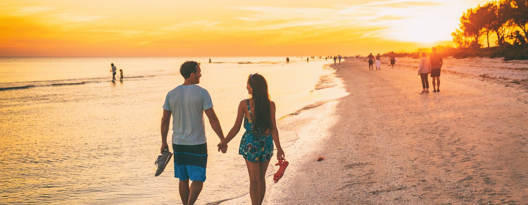 a man and woman walking on a beach