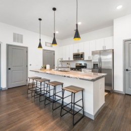 a kitchen with an island and bar stools