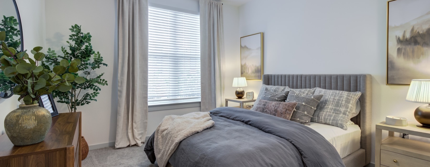 a bedroom with a bed and a plant